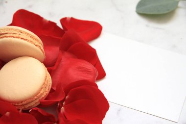 Gül yaprakları, kartpostal ve macaroons beyaz üzerine yapılan kalp