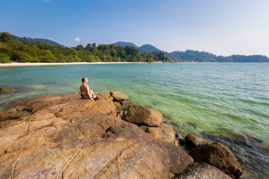 Young tourist on Teluk Nipah coral beach on Pangkor island in Malaysia. Beautiful landscape with sea  taken in south east Asia. clipart