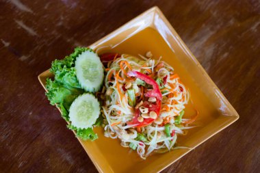 Taze papaya salatası Koh Lanta Island yerel restoranda Asya baharatlı Som Tam hazırlanmış. Taze malzemelerle yapılan geleneksel Tayland mutfağı.