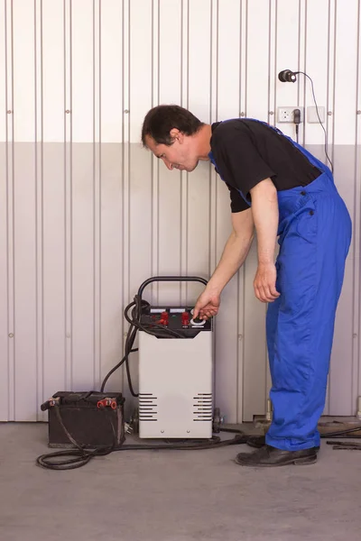 Mechanic Charging Battery Charger Auto Service Stock Photo