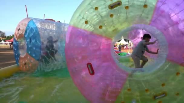 Los niños juegan globo flotante en la piscina . — Vídeos de Stock