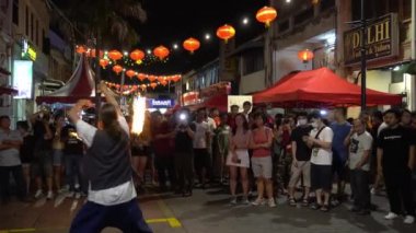 Bir adam sokakta ateş oyunu oynuyor..