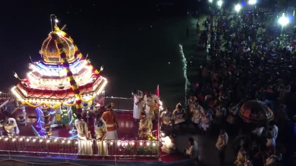 Devotees raise up hand and pray at floating chariot festival — Stock Video