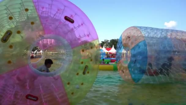 Kinder drehen sich im Schwimmerrad am Pool. — Stockvideo