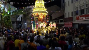 Hindu rahip altın at arabasında gaz lambası taşıyor. Hayranlar ayağa kalkın ve dua edin..
