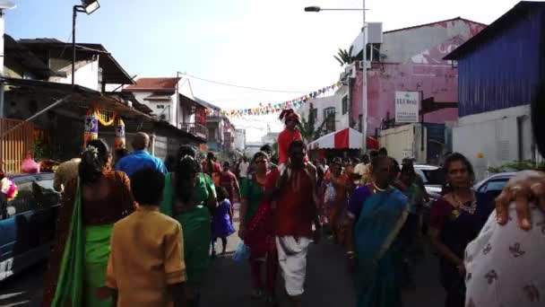 Hindoe vader houdt zijn zoon op hoofd op de weg tijdens Thaipusam processie. — Stockvideo