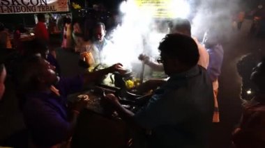 Thaipusam 'da dindarlar için hindistan cevizi kırma servisi.
