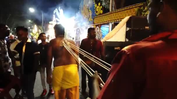 Indian devotees in kavadi pulled by his friend. — Stock Video