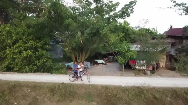 Dos niños es ciclo y sonrisa en el pueblo rural. — Vídeos de Stock