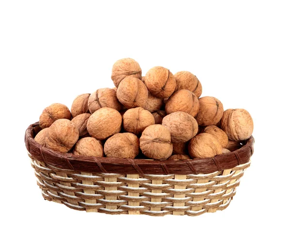 Inshell walnuts in a basket on an isolated white background. — Stock Photo, Image