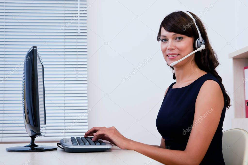 Call centre executive working on computer and interacting