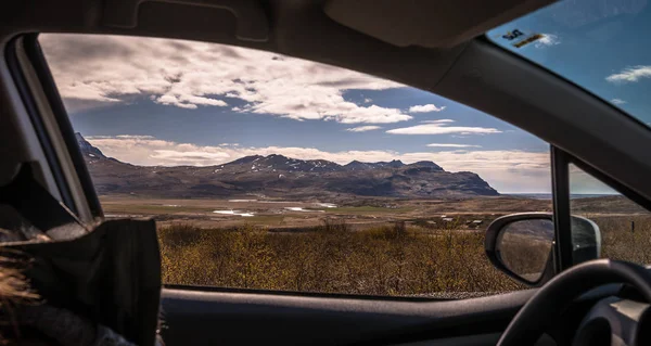 car on the road iceland mountain view