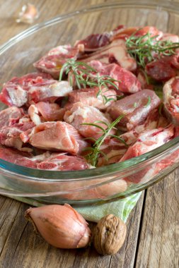 ham kuzu eti ve Türkiye bir cam tavada, pişirmeye hazır rosemary ile karışımı