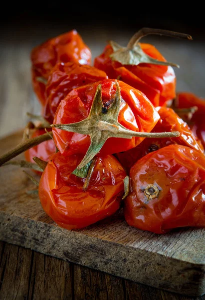 Dried cherry tomatoes on wooden — Stock Photo, Image