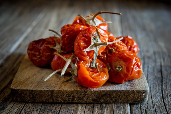 Dried cherry tomatoes on wooden — Stock Photo, Image