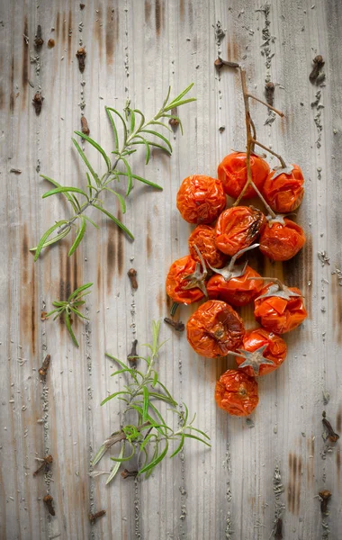 Dried cherry tomatoes on wooden — Stock Photo, Image