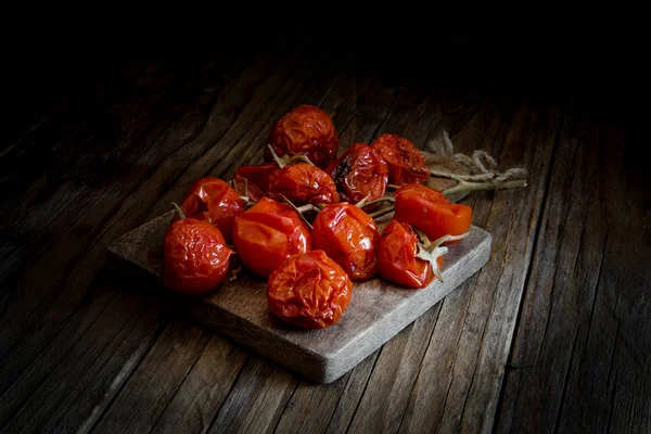 dried cherry tomatoes on wooden