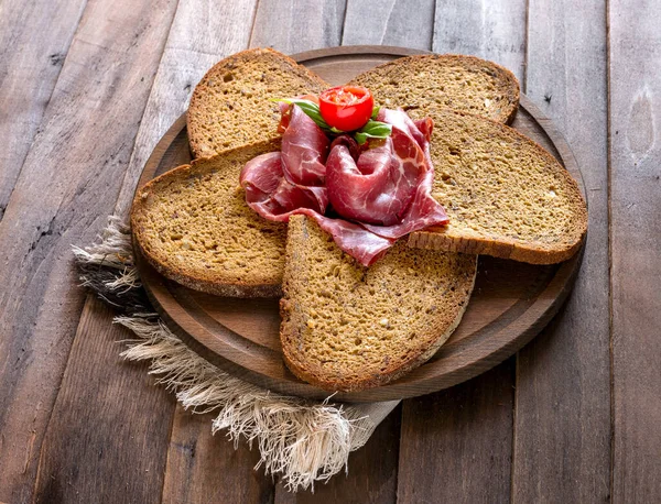 Bresaola ham on slices bread — ストック写真