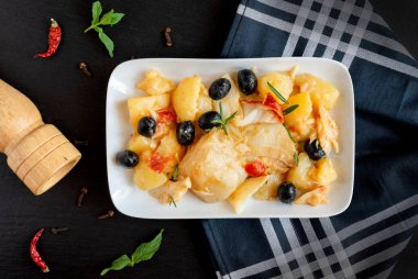 top view of Baked Codfish baccala Recipe with Potatoes and Olives clipart