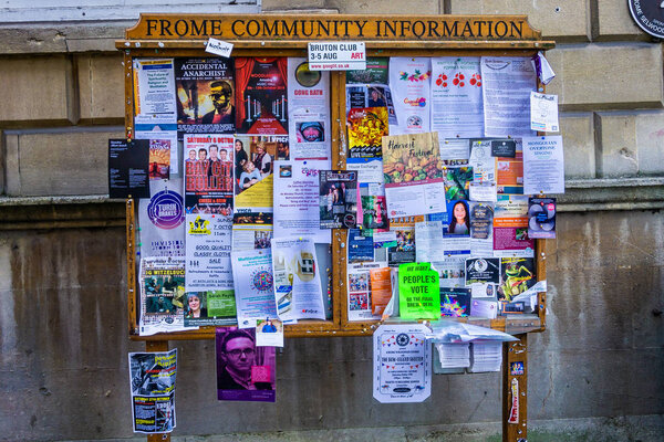 Frome Community notice board covered with leaflets and flyers taken in Frome, Somerset, UK on 3 October 2018