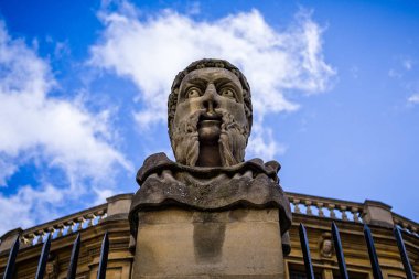 Scary stone head statue outside the Sheldonian Theatre in Oxford, Oxforshire, UK taken on 31 January 2018 clipart