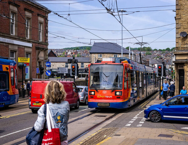 Tram arriving at passnger stop in Sheffield, Yorkshire, UK on 18 May 2018
