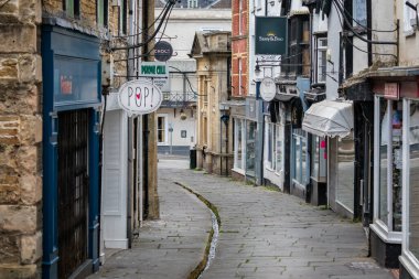 Su, 31 Mayıs 2020 'de Frome, Somerset, İngiltere' deki ıssız Cheap Caddesi 'nde bir kanaldan akıyor.