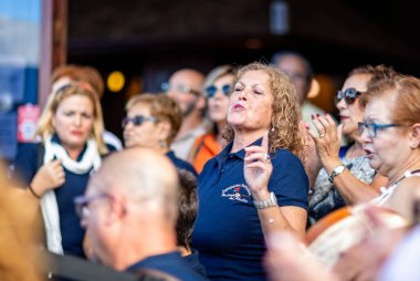 23 Kasım 2019 'da İspanya, Tenerife' deki bir barın önünde tutkuyla şarkı söyleyen kadının yakınları.