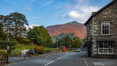 View of shops in Grasmere with Hellvellyn mountain range in background in Grasmere, Lake District, Cumbria, UK on 21 September 2020 clipart