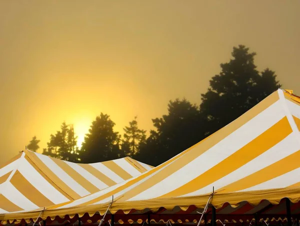 striped events or wedding tent in the glow of sunset
