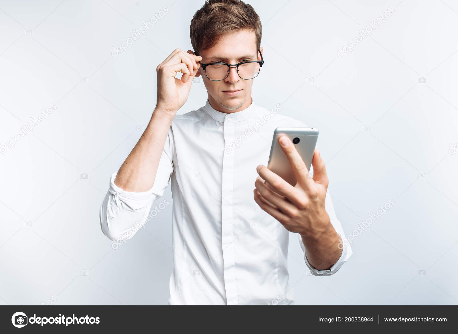 Portrait Young Attractive Guy Glasses Looking Phone White Shirt