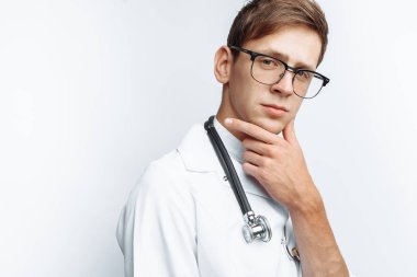 Beyaz bir arka planda stajyer stüdyoda genç bir doktor portresi