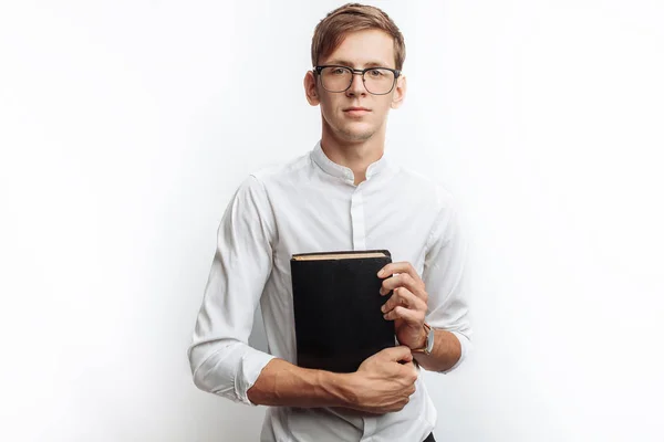 Man reading Bible, white background, book in hand close-up, isolated