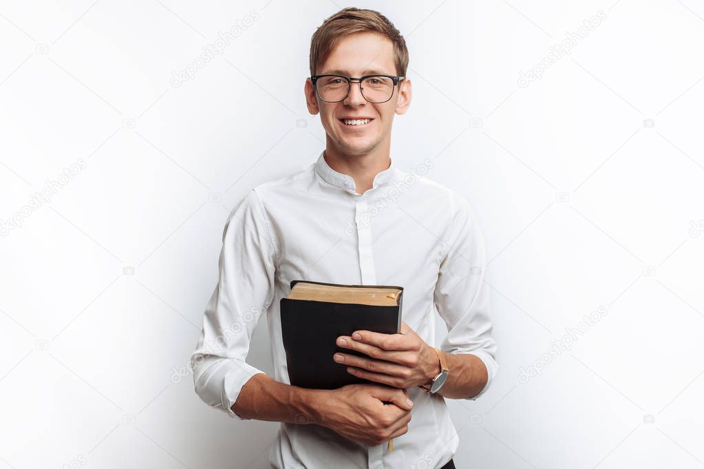 Man reading Bible, white background, book in hand close-up, isolated