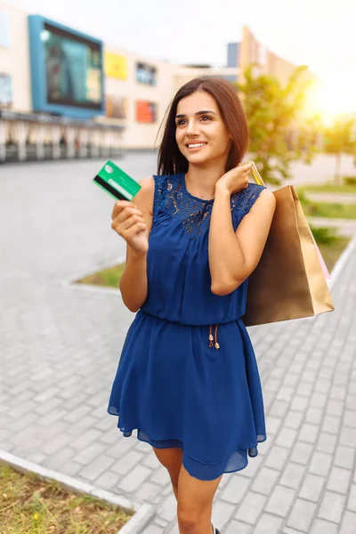 girl with shopping and card on the street, payment card