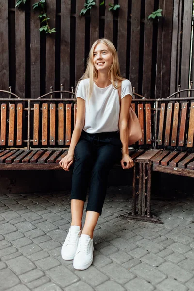 Jovem Menina Bonita Uma Camiseta Branca Sentado Banco Contra Uma — Fotografia de Stock