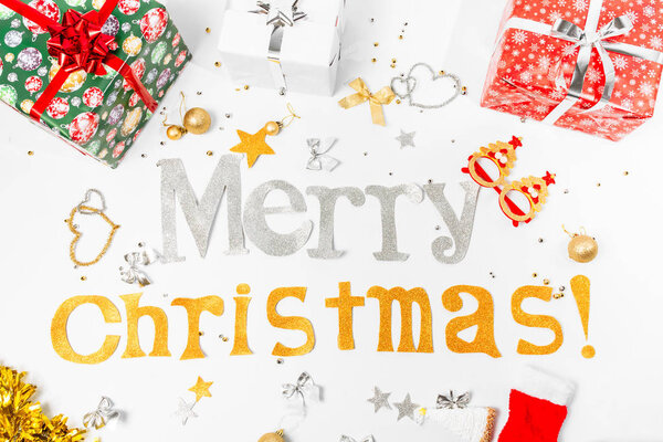 Inscription Congratulations on Merry Christmas and Happy New Year with gift boxes and Christmas toys, on a white background.