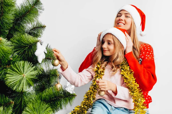 Mom Daughter Wearing Santa Claus Hats Decorate Christmas Tree Together Stock Photo