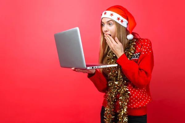 Girl Red Sweater Hat Santa Claus Laptop His Hands Looks — Stock Photo, Image