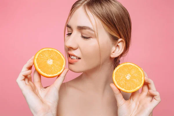 Aantrekkelijke lachende meisje met schone huid en oranje stukken op een p — Stockfoto