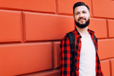 boş bir tuğla duvarın arka planında sakallı adam