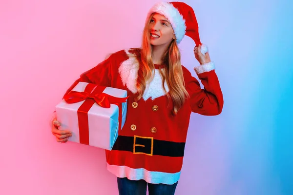 Happy girl in Santa hat holding big gift box isolated on background — Stock Photo, Image