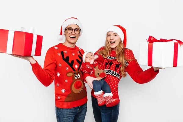 Happy family, mom, dad and little baby with christmas gifts isolated on white background — Stock Photo, Image