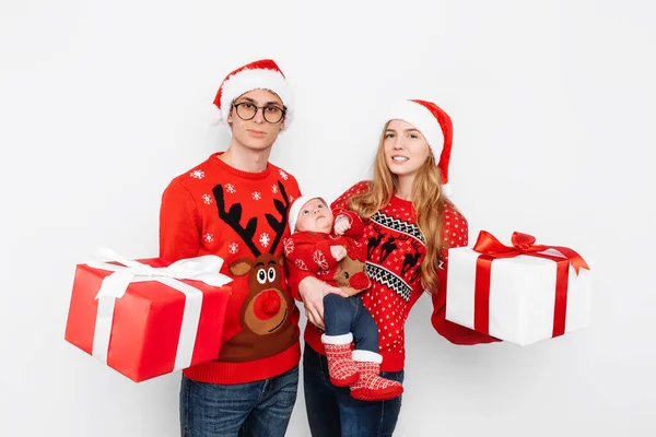 Happy family, mom, dad and little baby with christmas gifts isolated on white background — Stock Photo, Image