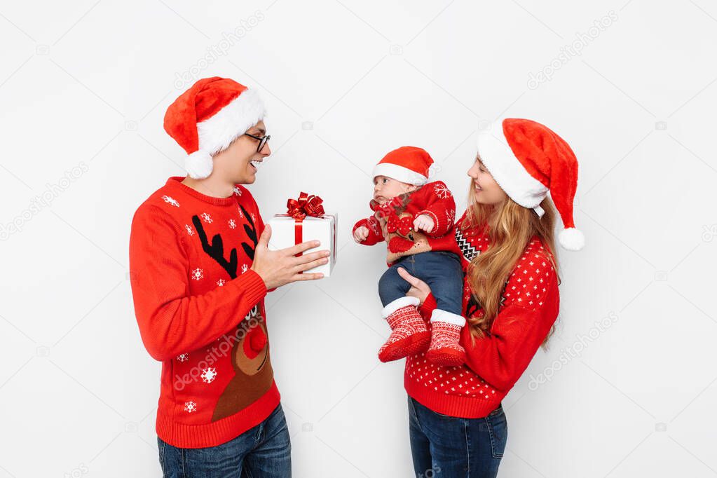 Happy family, dad mom and little baby, celebrate Christmas and g