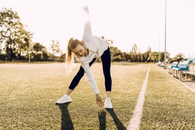 Çekici zayıf atletik kadın açık havada esneme egzersizleri yapıyor. Spor, koronavirüs, karantina