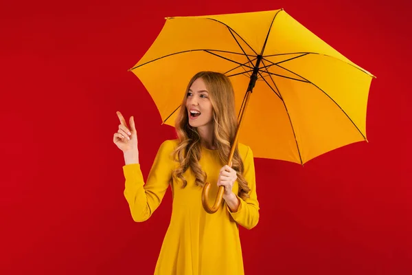 Happy Young Woman Yellow Umbrella Pointing Copy Space Empty Red — Stock Photo, Image