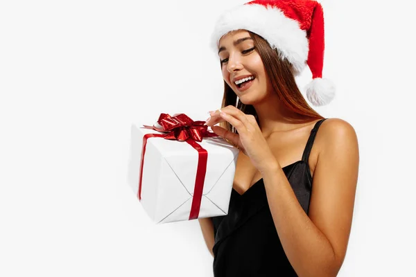 Cheerful Brunette Red Christmas Hat Black Dress Holding Gift Box — Stock Photo, Image