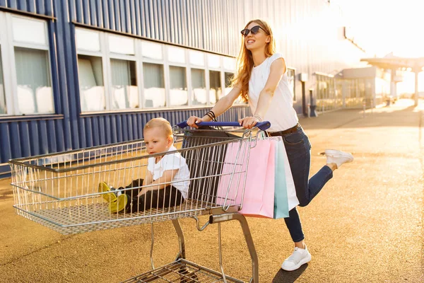 Emocionada Joven Madre Con Niño Bolsas Compras Diversión Corriendo Con — Foto de Stock