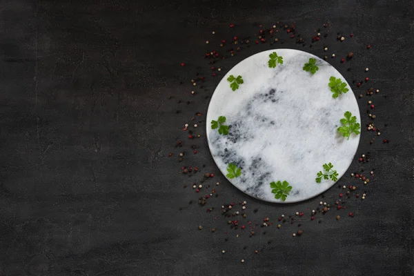 Condiments and spices on round stone board. Top view, close-up o